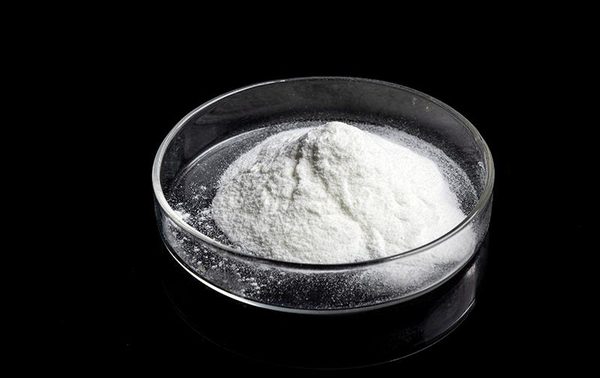 White poly aluminium chloride PAC powder sample in glass petri dish against black background